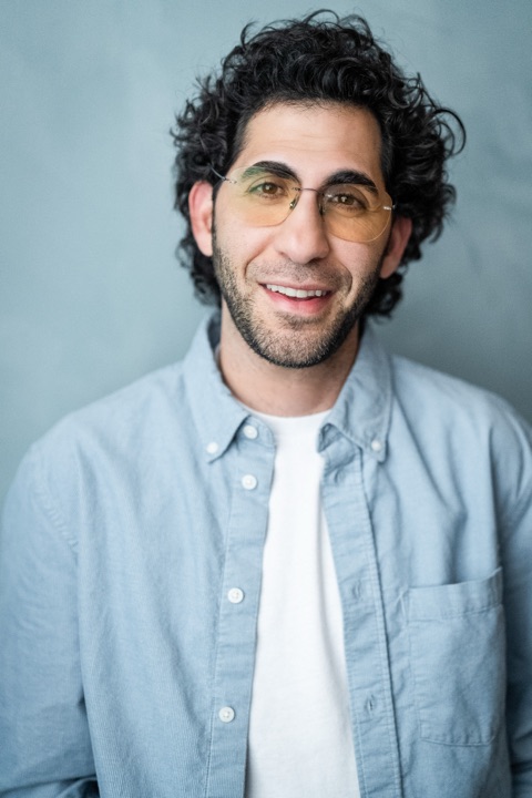 Luca Cundo smiling in tinted glasses and a light blue shirt