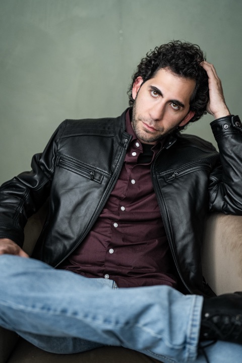 Luca Cundo in a leather jacket, hand in his hair