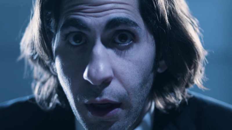 Luca Cundo as Derek Ford in Sandtrap, lit in blue during an interrogation