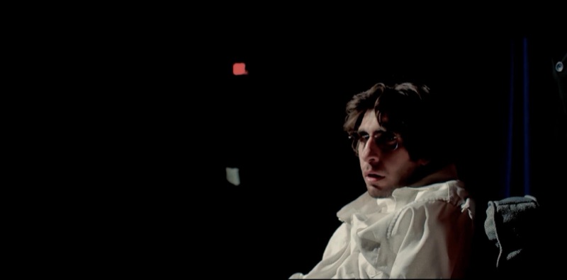 Luca Cundo in a white shirt in near darkness in The In-Between Hour